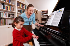 Teacher with girl pianist